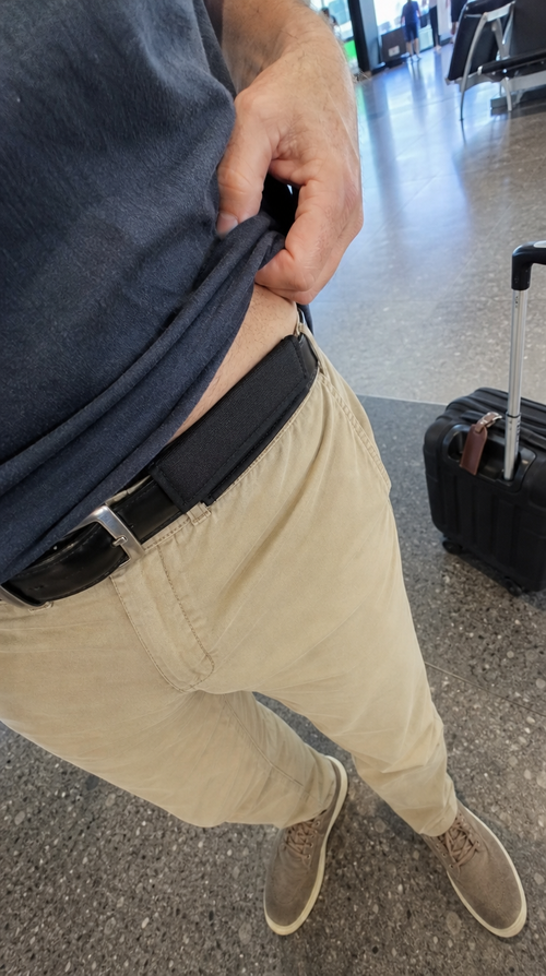 Hidden money belt pouch on a belt, worn while travelling through an airport
